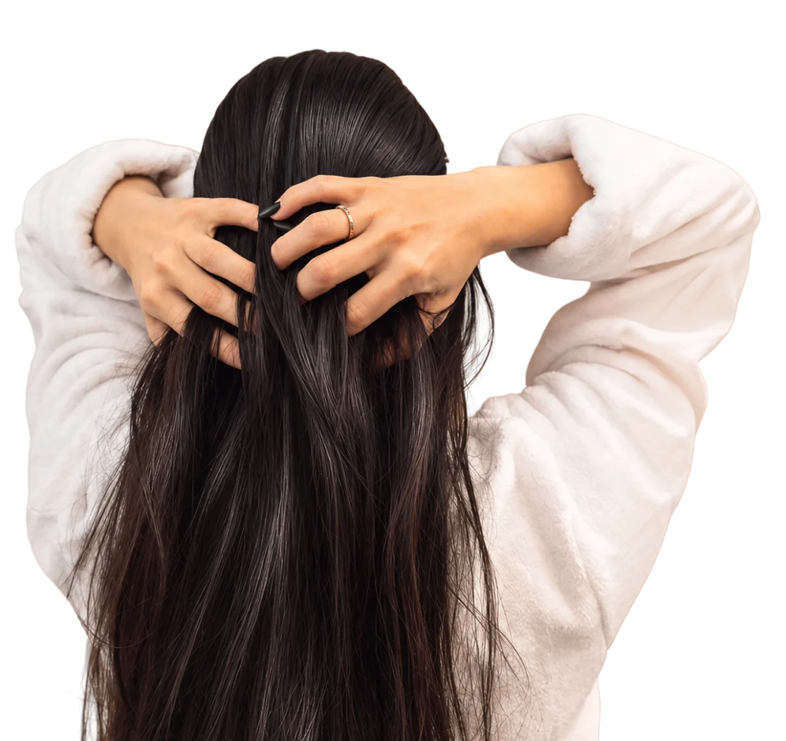Woman from behind running her hands through long, glossy hair